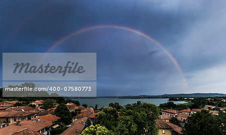 Rainbow over lake of Varese, panorama from Biandronno - Lombardy, Italy