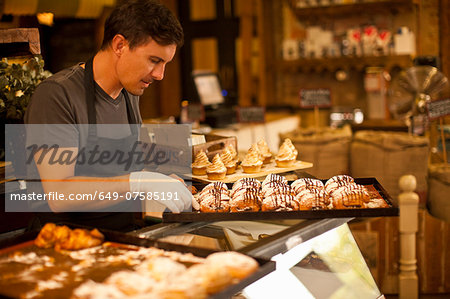 Mature man with tray of fresh pastries