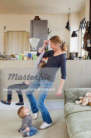 Mid adult mother playing with her two young daughters