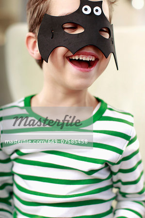 Portrait of young boy in bat mask