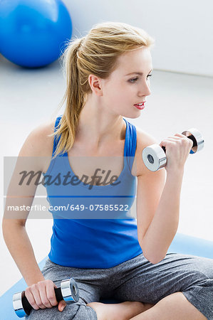 Young woman lifting weights