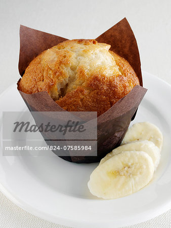 Banana muffin with fruit on a white plate