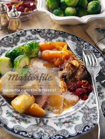 Roast turkey slices with stuffing Brussels sprouts baby carrots roast potatoes and gravy Christmas dinner