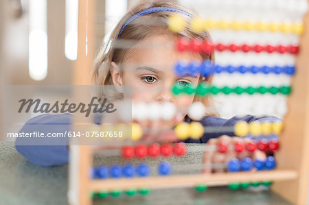 Young girl learning on abacus