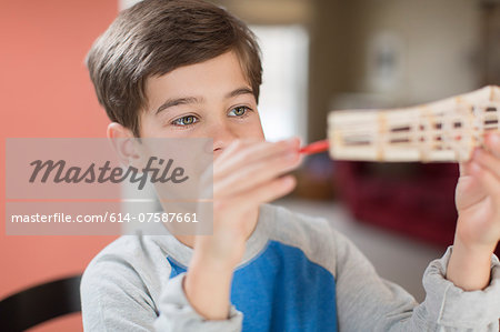 Boy holding up handmade model
