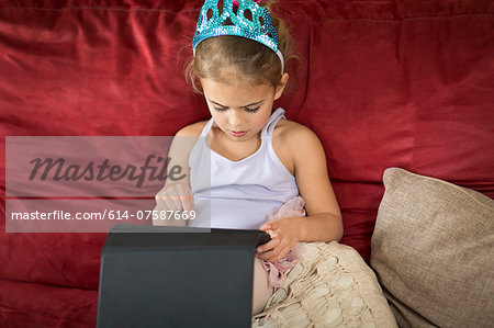 Young girl using touchscreen on digital tablet