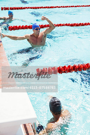 Swimmer celebrating in pool