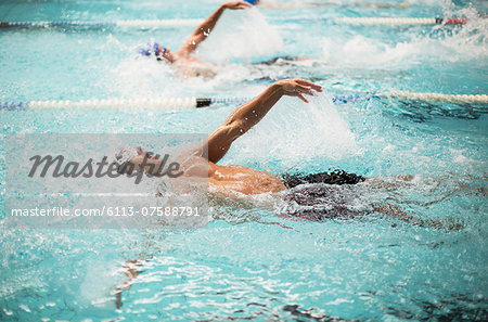 Swimmers racing in pool