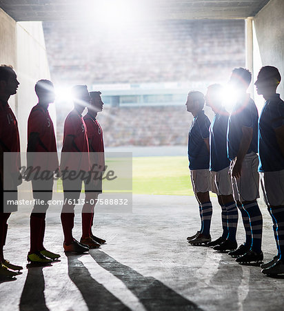 Silhouette of soccer teams greeting in locker room