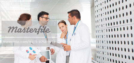 Doctors talking in hospital corridor