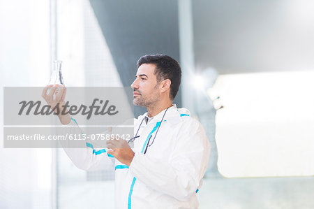 Scientist examining liquid in beaker