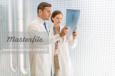 Doctors examining paperwork in hospital