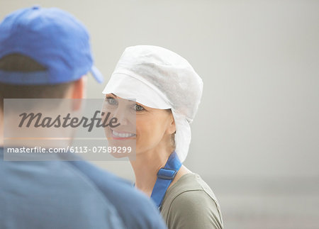 Workers talking in food processing plant