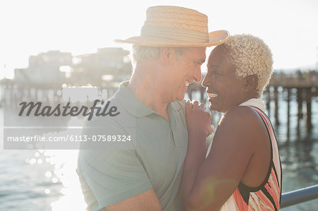 Senior couple hugging on pier