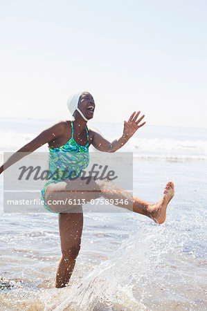 Woman splashing in ocean surf