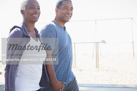 Senior couple holding hands and walking