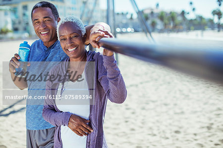 Portrait of smiling senior couple on beach playground