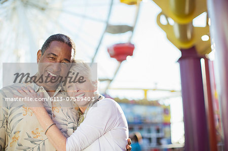 Portrait of smiling senior couple at amusement park