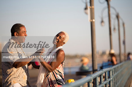 Senior couple dancing on pier