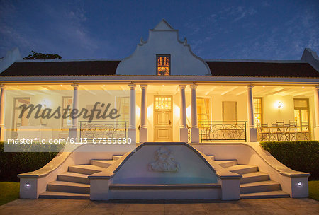 Luxury house with porch illuminated at night
