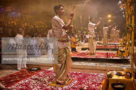 Hindu priests at sundown Aarti Ritual Ceremony of Light during Shivrati Festival in Holy City of Varanasi, Benares, India