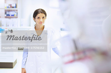Portrait of young female pharmacist in pharmacy
