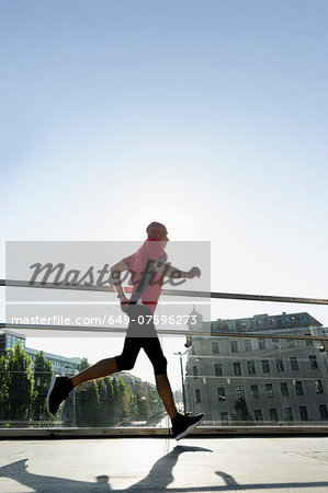 Runner crossing bridge, Munich, Germany