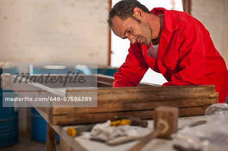 Carpenter working on wooden frame