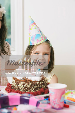 Portrait of young girl enjoying her birthday party