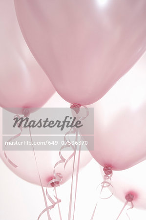 Still life of five pink balloons on ribbons