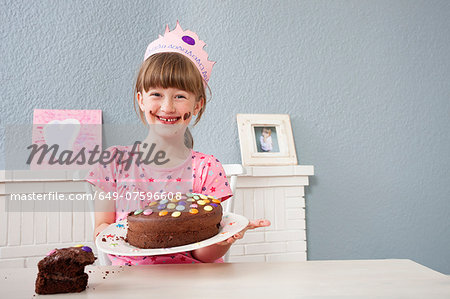 Girl showing off her birthday cake