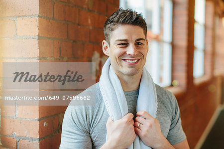 Man in gym with towel around neck