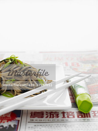 Japanese soba noodles on a white plate with white chopsticks