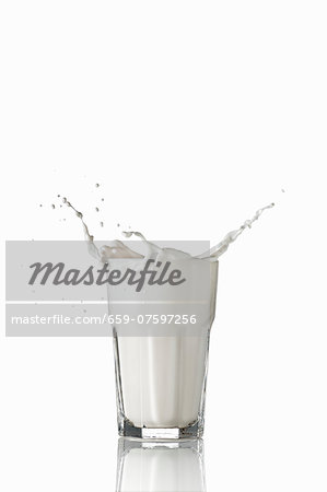 Milk splashing out of glass