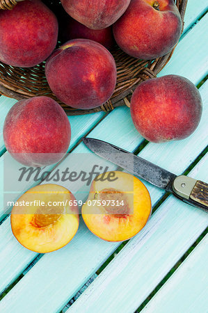Peaches with a basket and a knife