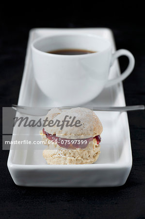 cup of coffee with small scone cup of coffee with small scone