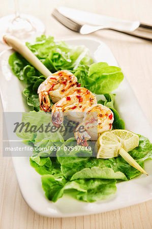 Grilled marinated king prawns on a lemongrass skewer Grilled marinated king prawns on a lemongrass skewer