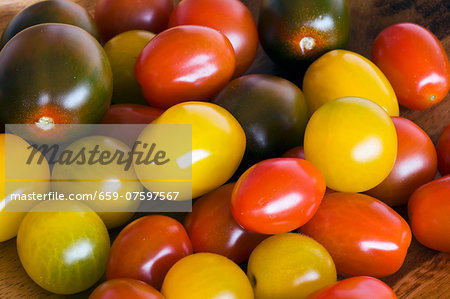 Yellow, red and black cherry tomatoes (filling the image)