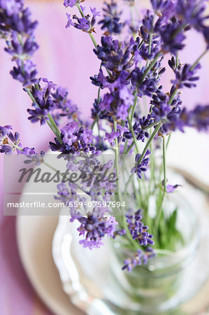 Lavender flowers in a glass of water as a table decoration