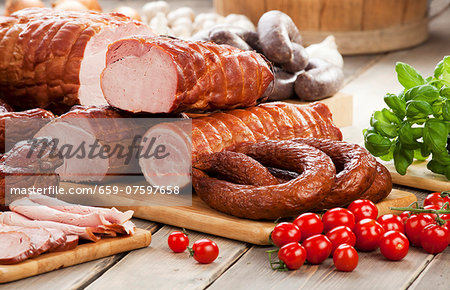 Assorted sausages and ham, cherry tomatoes, basil and garlic