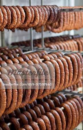 Lots of sausages hanging in a smoke house