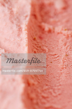Track left by an ice cream scoop in fresh home-made strawberry ice cream Track left by an ice cream scoop in fresh home-made strawberry ice cream