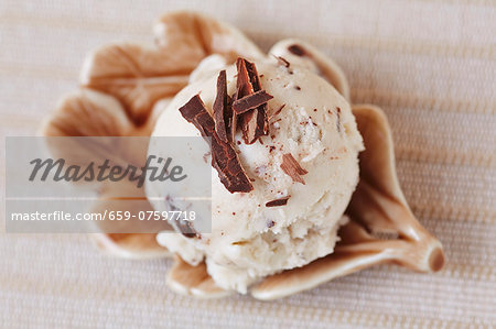 A scoop of home-made stracciatella ice cream with grated chocolate