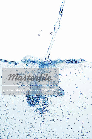 A jet of water shooting into a basin of water A jet of water shooting into a basin of water