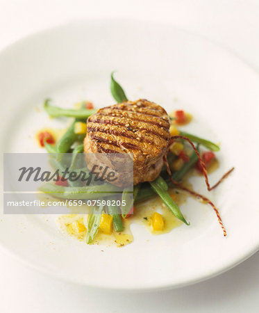 Grilled medallion of beef on green beans