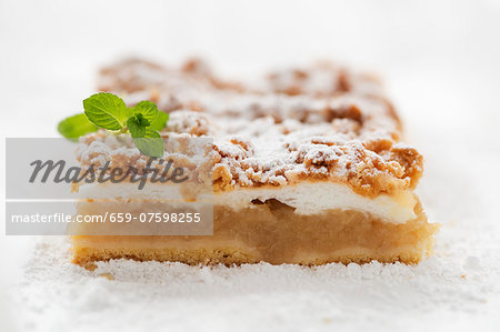 A slice of apple pie with crumble topping