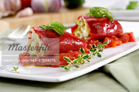 Peppers stuffed with cod on stewed tomatoes