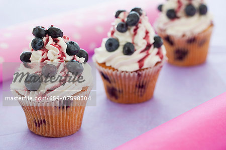 Blueberry cupcakes with mascarpone icing and cherry sauce