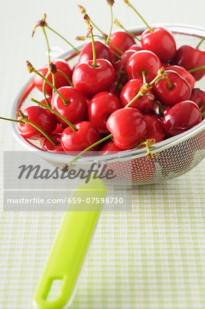 Fresh cherries in a sieve