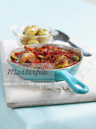 Chicken stew with peppers and olives, with parsley potatoes on the side